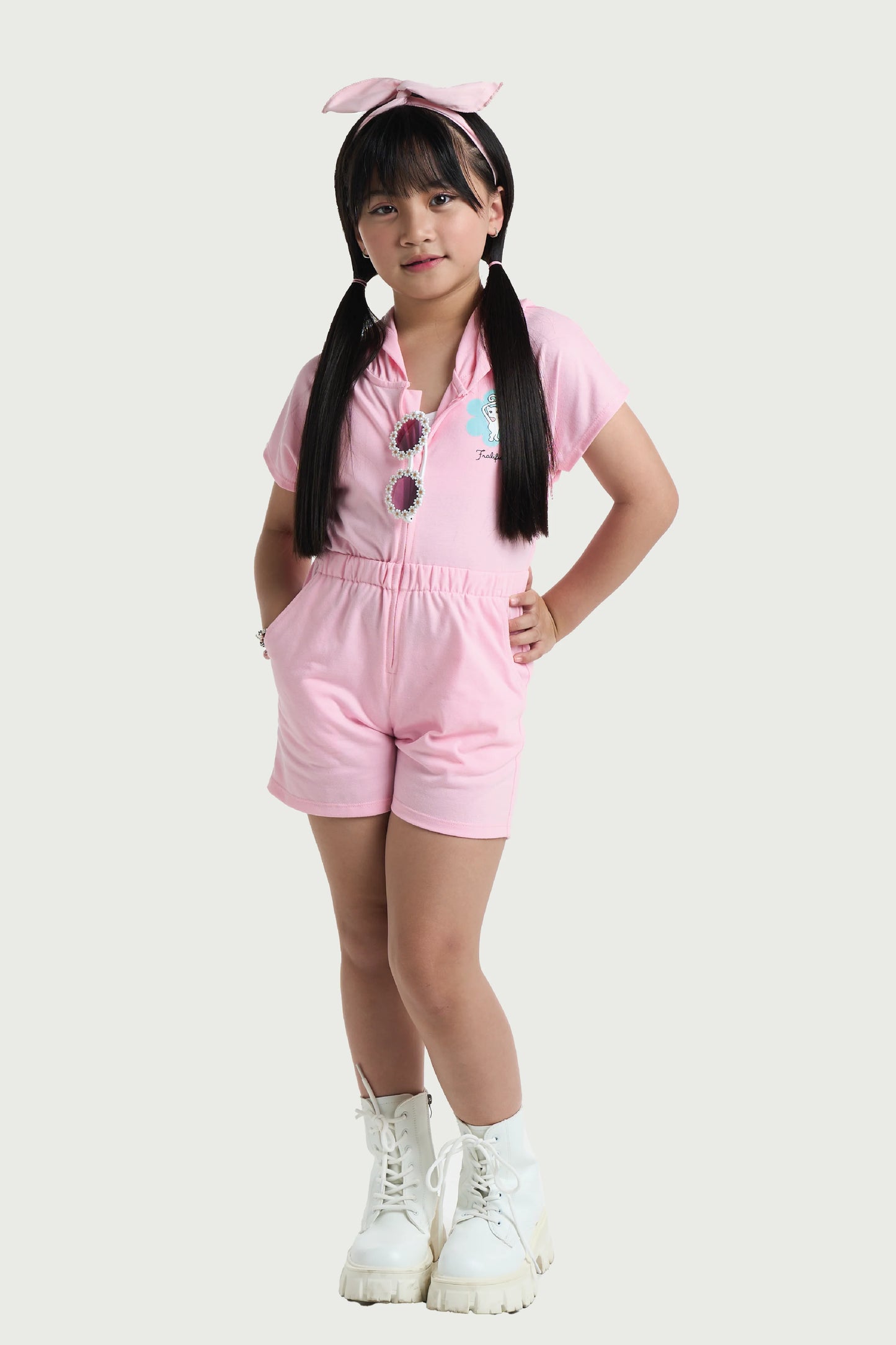 Toddler girl wearing pink cotton romper with hood and button front