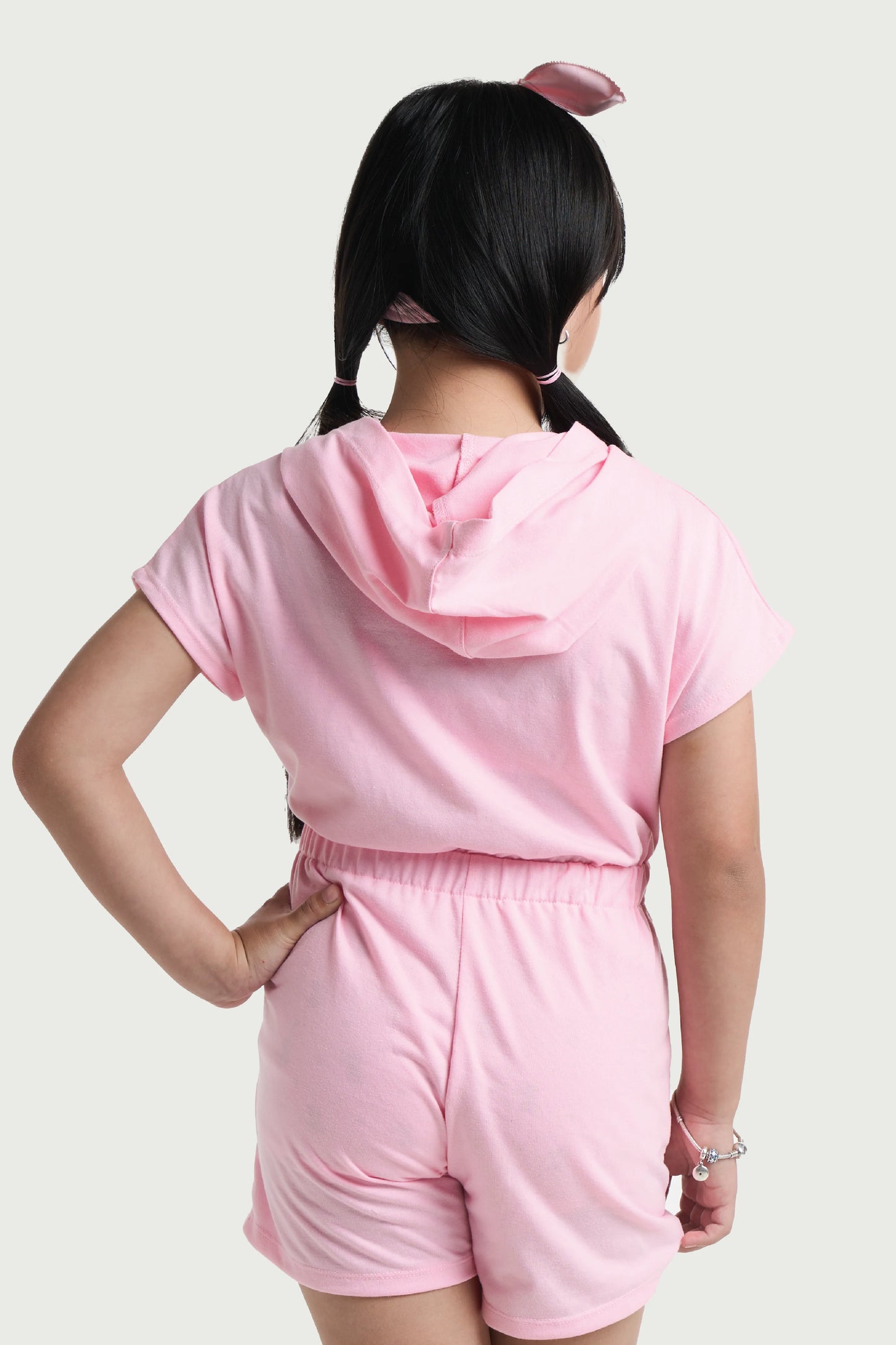 Back view of pink girls hooded romper with elastic waistband