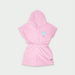 Back side flat lay of pink cotton romper for toddlers with hood and stitching detail