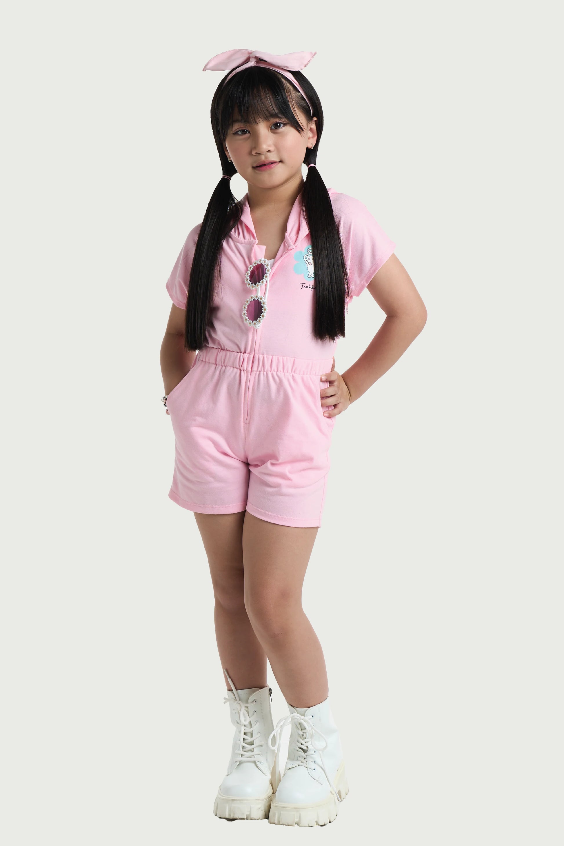 Toddler girl wearing pink cotton romper with hood and button front