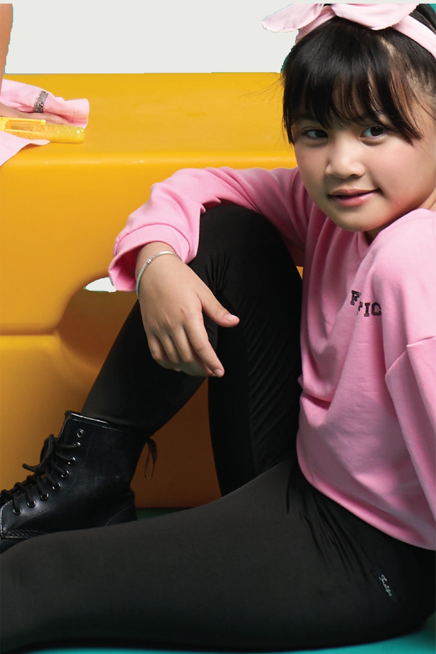 Child in black leggings and pink top with hair bow – cozy black cotton leggings for toddlers