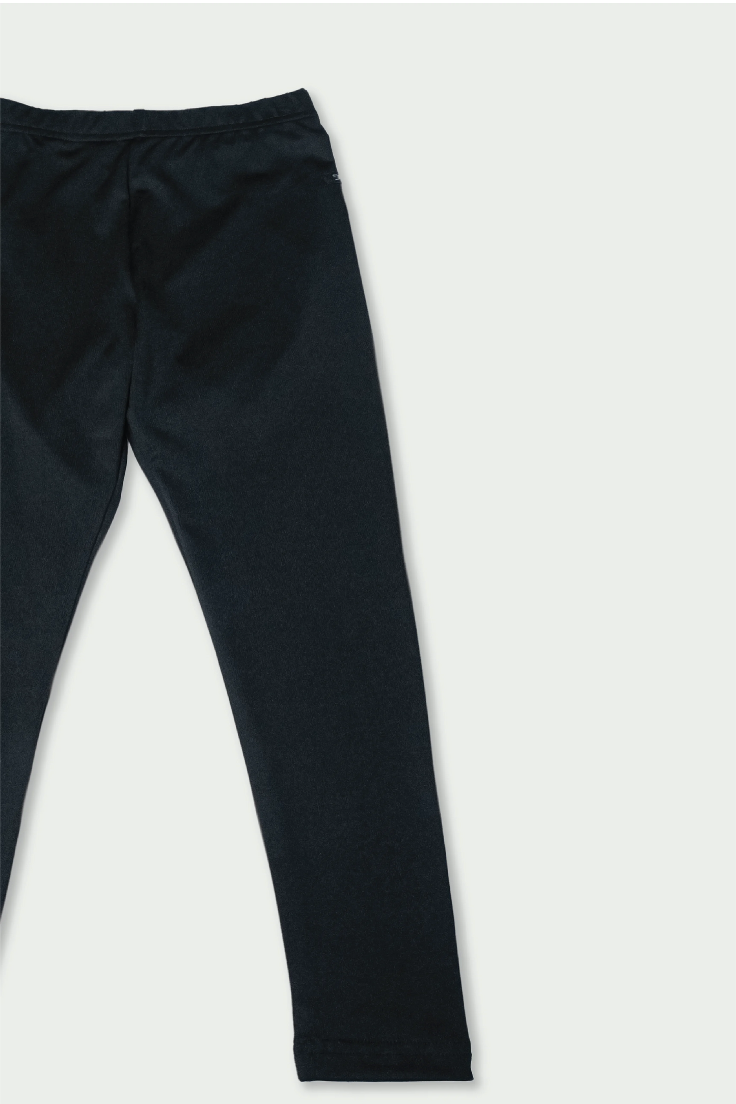 Flat lay of black cotton kids leggings – soft stretch fabric for all-day toddler comfort