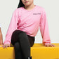 Girl in black cotton leggings and pink top sitting on yellow bench – comfy and stylish kidswear